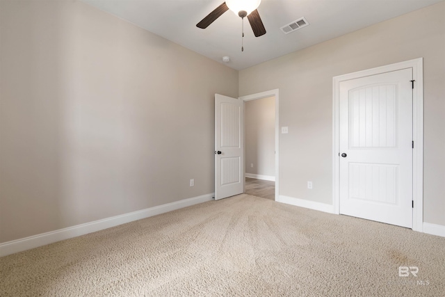 unfurnished bedroom with ceiling fan and carpet floors