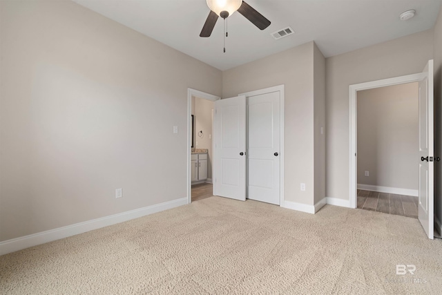 unfurnished bedroom featuring ceiling fan and light carpet