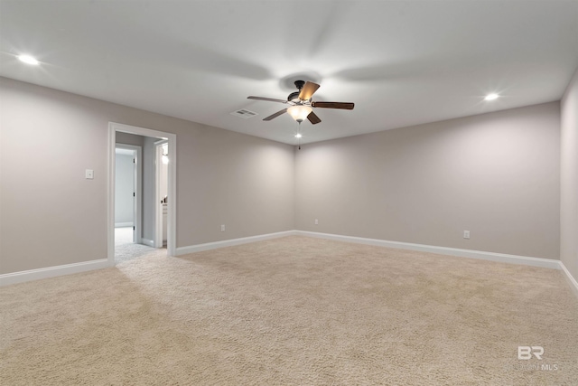 empty room featuring ceiling fan and light colored carpet