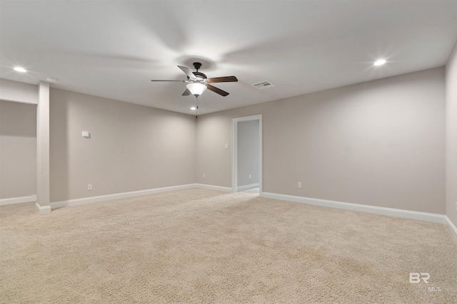 carpeted spare room with ceiling fan