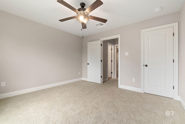 unfurnished bedroom featuring ceiling fan and light colored carpet