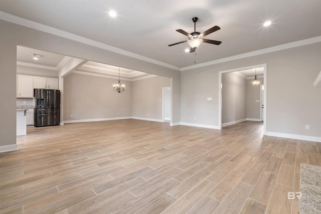 unfurnished living room with ceiling fan with notable chandelier, light hardwood / wood-style flooring, and crown molding