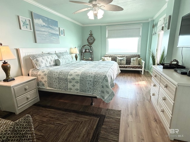 bedroom with dark wood-style floors, ornamental molding, and a ceiling fan