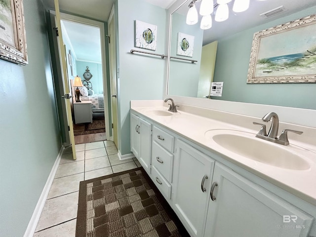 ensuite bathroom featuring tile patterned floors, visible vents, a sink, and double vanity