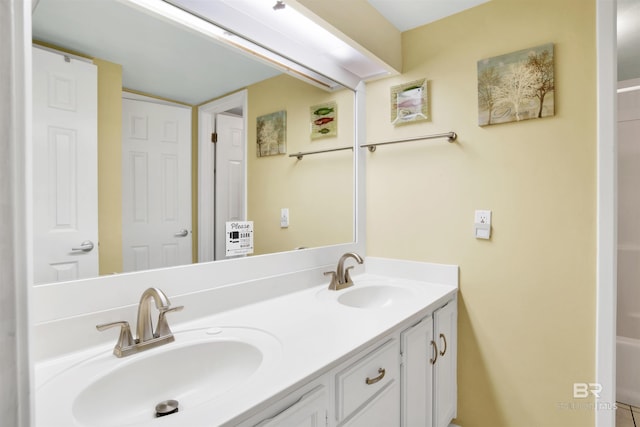 full bathroom with a sink and double vanity