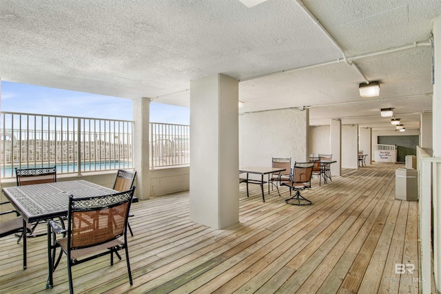 wooden terrace with outdoor dining area