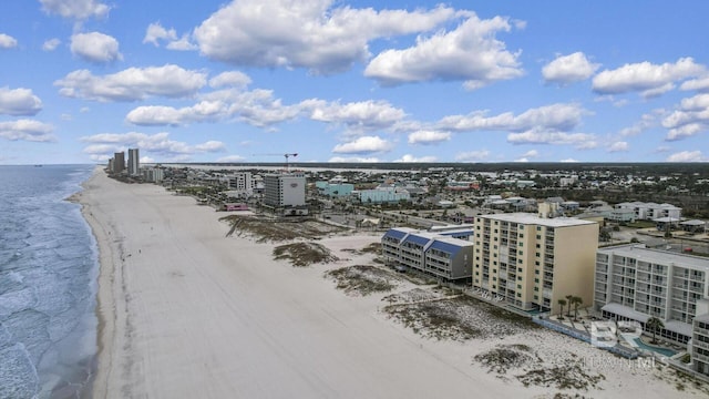 drone / aerial view featuring a beach view, a water view, and a view of city