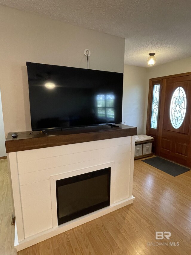 foyer with a textured ceiling and hardwood / wood-style floors