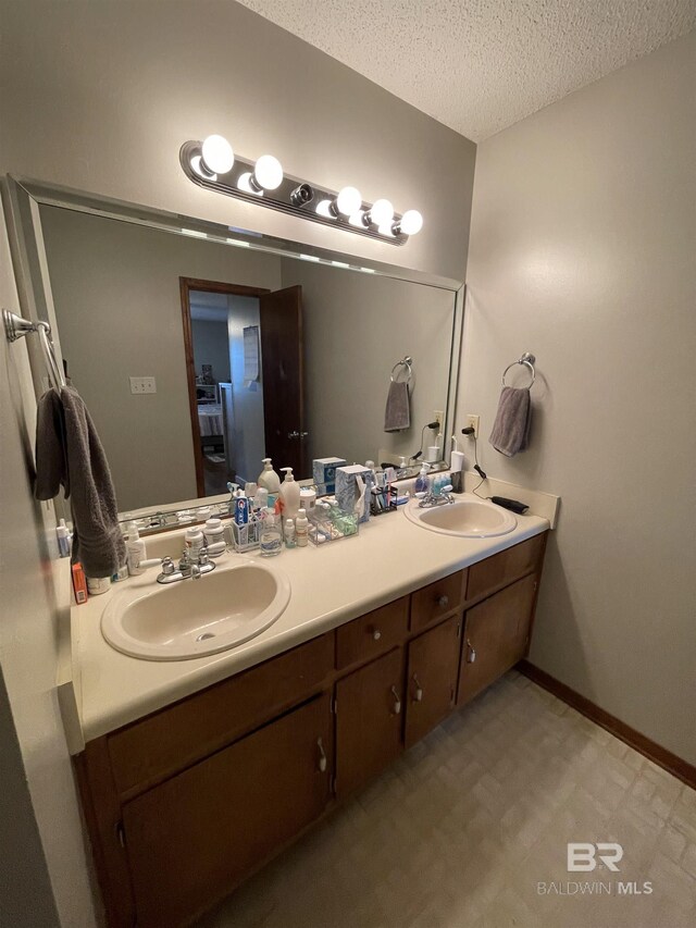 bathroom featuring vanity and a textured ceiling