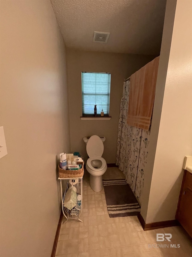 bathroom with toilet, a textured ceiling, a shower with shower curtain, and vanity