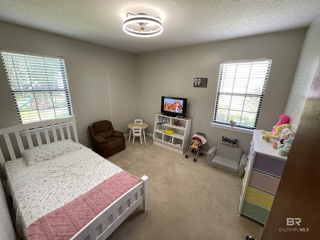 bedroom featuring a textured ceiling and carpet