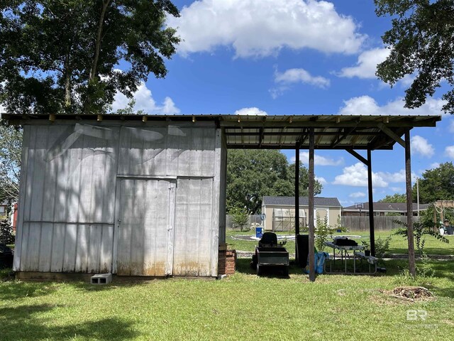 view of outbuilding with a lawn