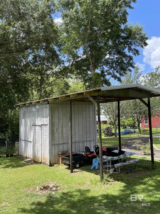 view of outbuilding featuring a lawn