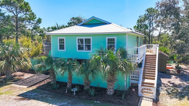 exterior space with stairway and metal roof