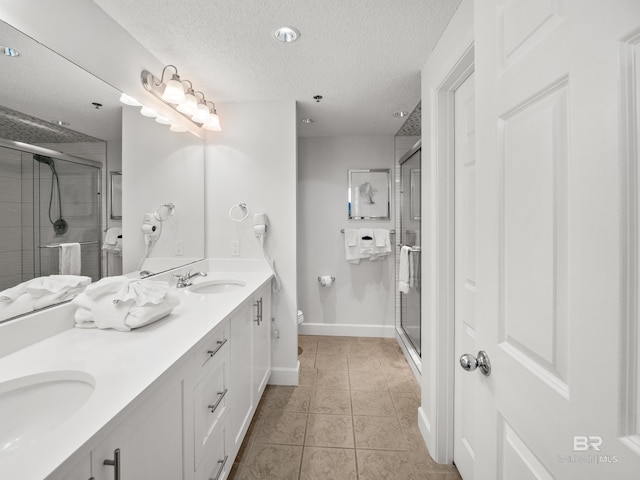 375 Beach Club Trl Unit A1710, Gulf Shores, AL 36542 - full bath with double vanity, a shower stall, a textured ceiling, and tile patterned flooring
