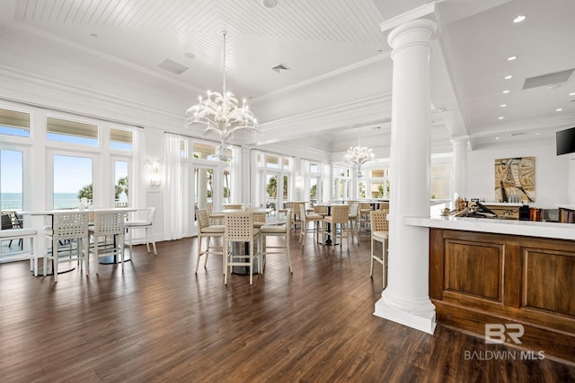 375 Beach Club Trl Unit A1710, Gulf Shores, AL 36542 - dining space with ornate columns, dark wood-style flooring, a chandelier, crown molding, and a water view