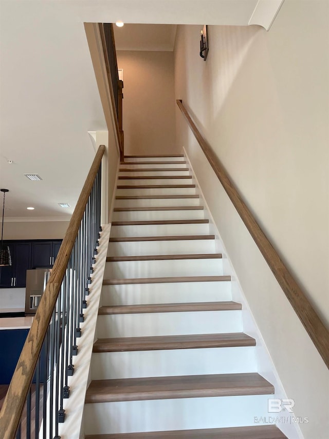 staircase with crown molding