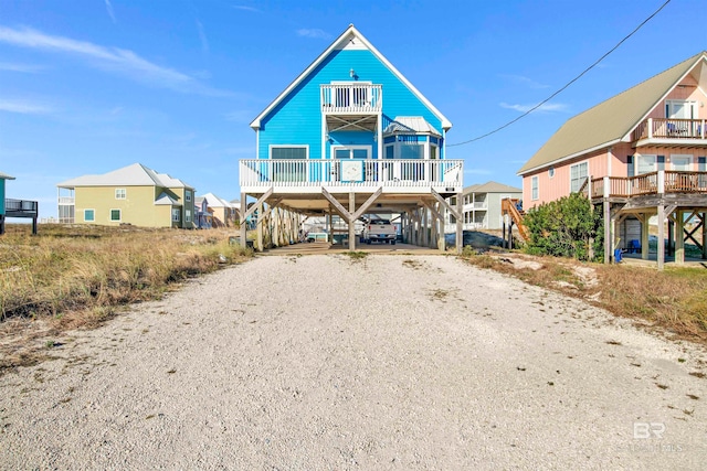 rear view of property with a balcony and a deck