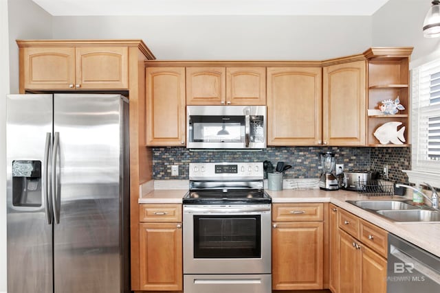 kitchen featuring light brown cabinetry, tasteful backsplash, stainless steel appliances, and sink