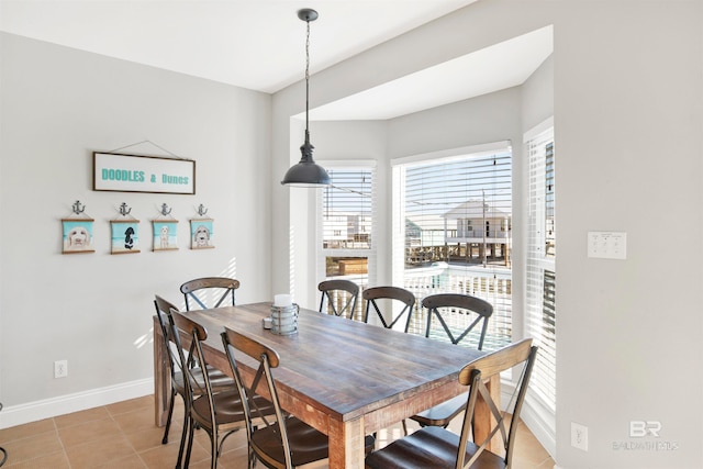 dining space featuring light tile floors