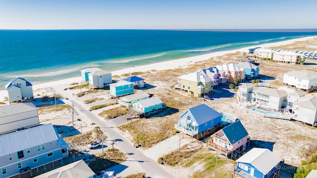 drone / aerial view featuring a water view and a beach view