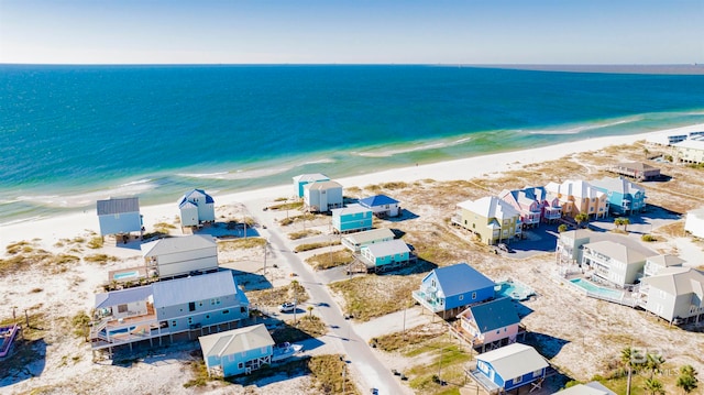 drone / aerial view featuring a water view and a view of the beach