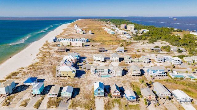 bird's eye view with a water view and a beach view