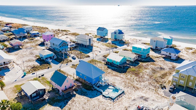 drone / aerial view featuring a water view and a beach view