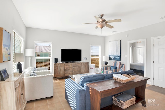 tiled living room featuring ceiling fan