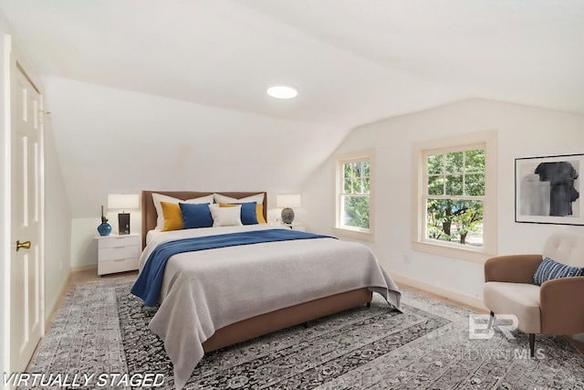 carpeted bedroom with vaulted ceiling