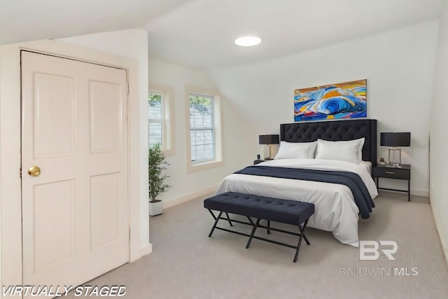 carpeted bedroom featuring lofted ceiling