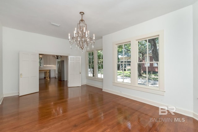 interior space featuring an inviting chandelier and dark hardwood / wood-style floors