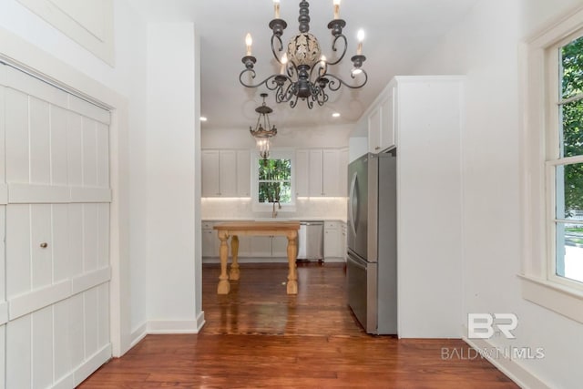 kitchen with white cabinets, a wealth of natural light, and appliances with stainless steel finishes