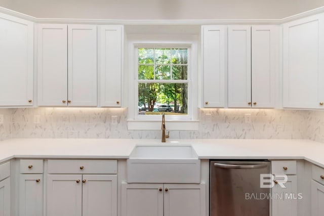 kitchen with sink, stainless steel dishwasher, tasteful backsplash, and white cabinetry