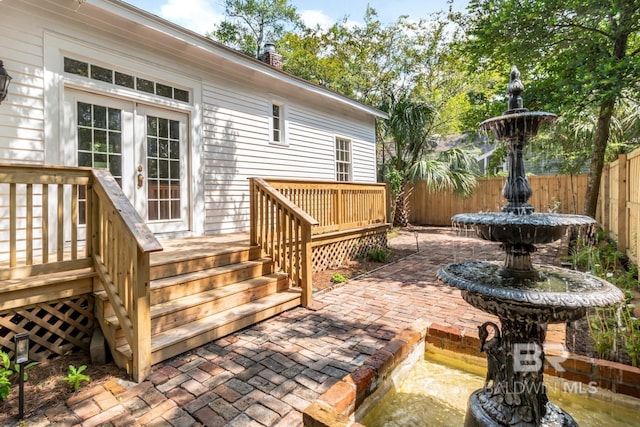 wooden terrace with french doors and a patio