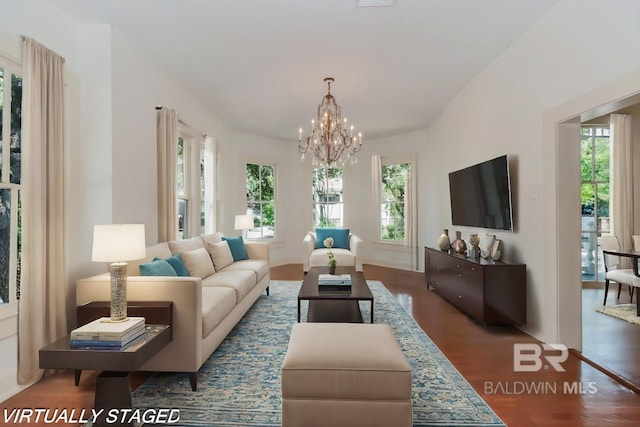 living room featuring an inviting chandelier and dark hardwood / wood-style floors