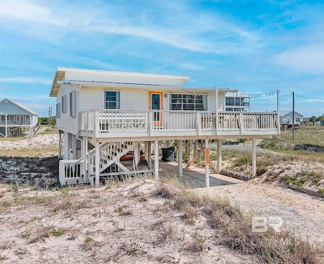 3425 Ponce De Leon Ct, Gulf Shores, AL 36542 - back of property with stairway, driveway, and a carport