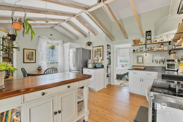 3425 Ponce De Leon Ct, Gulf Shores, AL 36542 - kitchen with open shelves, freestanding refrigerator, butcher block counters, light wood-style floors, and vaulted ceiling with beams