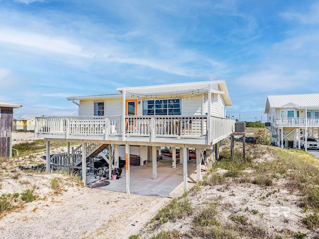 3425 Ponce De Leon Ct, Gulf Shores, AL 36542 - back of property with central air condition unit, a carport, stairs, and driveway