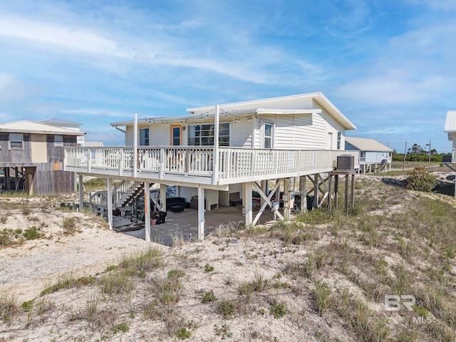 3425 Ponce De Leon Ct, Gulf Shores, AL 36542 - rear view of property featuring stairway, central AC unit, and a carport