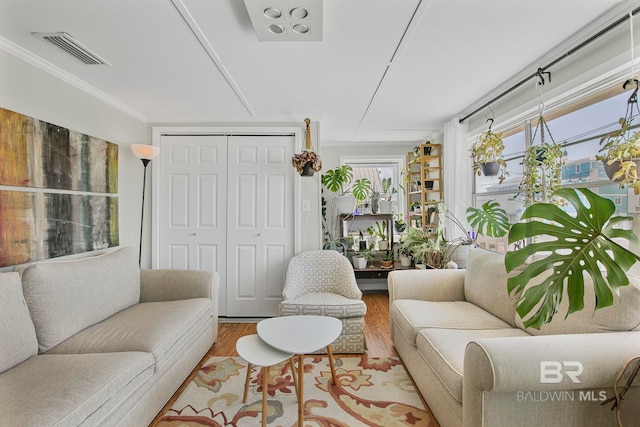 3425 Ponce De Leon Ct, Gulf Shores, AL 36542 - living room with visible vents, ornamental molding, wood finished floors, and a wealth of natural light