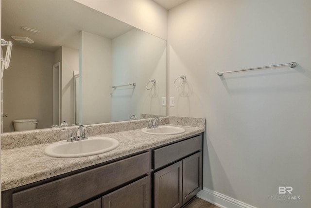 bathroom featuring vanity and toilet