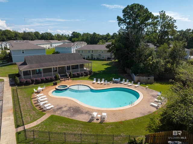 view of pool featuring a lawn and a patio area