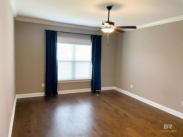spare room featuring dark wood-style flooring, ceiling fan, ornamental molding, and baseboards