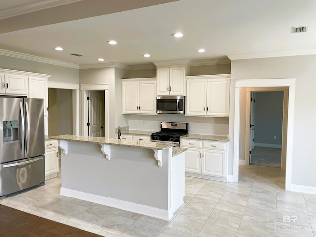 kitchen featuring recessed lighting, tasteful backsplash, a breakfast bar area, stainless steel appliances, and ornamental molding
