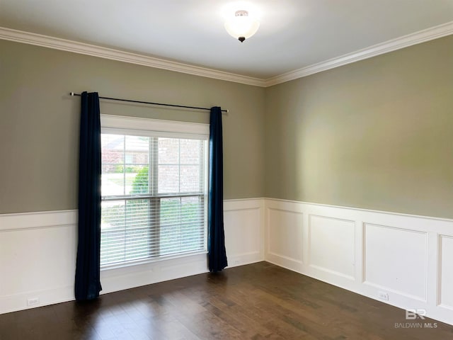 unfurnished room featuring dark wood-type flooring, ornamental molding, and wainscoting