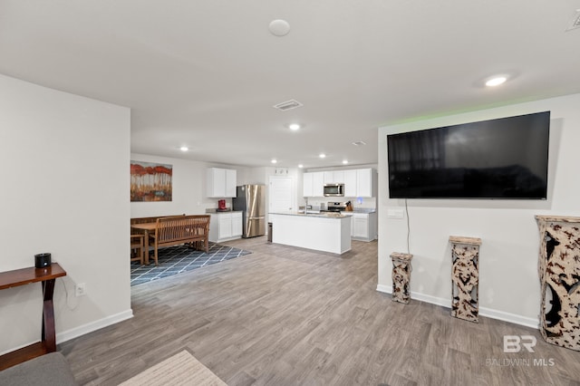 living room with light hardwood / wood-style flooring