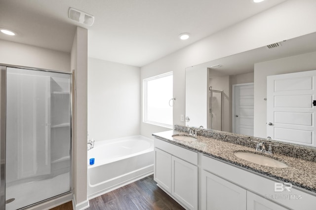 bathroom with shower with separate bathtub, vanity, and hardwood / wood-style flooring