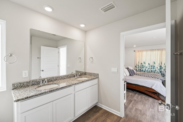 bathroom with hardwood / wood-style floors and vanity