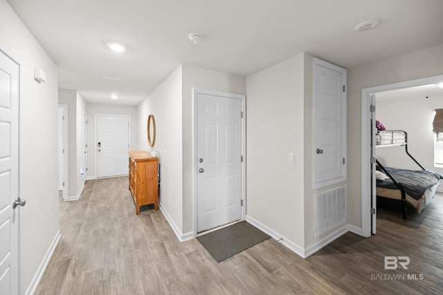 corridor featuring light hardwood / wood-style flooring